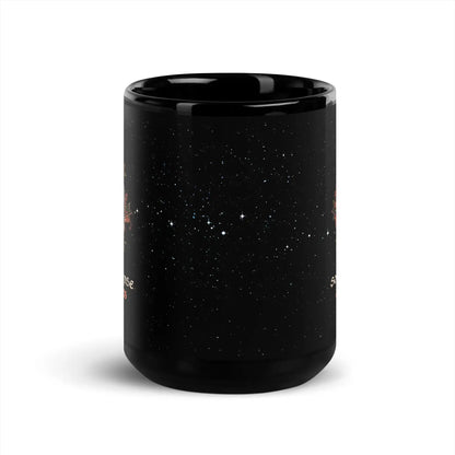 15oz black ceramic mug showing a starry space design with white stars and small orange celestial illustrations seen on the left and right sides, shown on a clean white background.