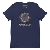A navy blue short-sleeve t-shirt with a graphic of a solar eclipse by Xigfireon. The graphic features a detailed Sun face surrounded by orange and brown leaves, with the Spanish text &