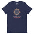 A navy blue short-sleeve t-shirt with a graphic of a solar eclipse by Xigfireon. The graphic features a detailed Sun face surrounded by orange and brown leaves, with the Spanish text &