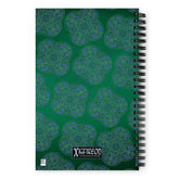 The back side of a Xigfireon graphic spiral notebook featuring the Living Colour Forest patterned series of the Reach Of The Spirit Celtic knot design.
