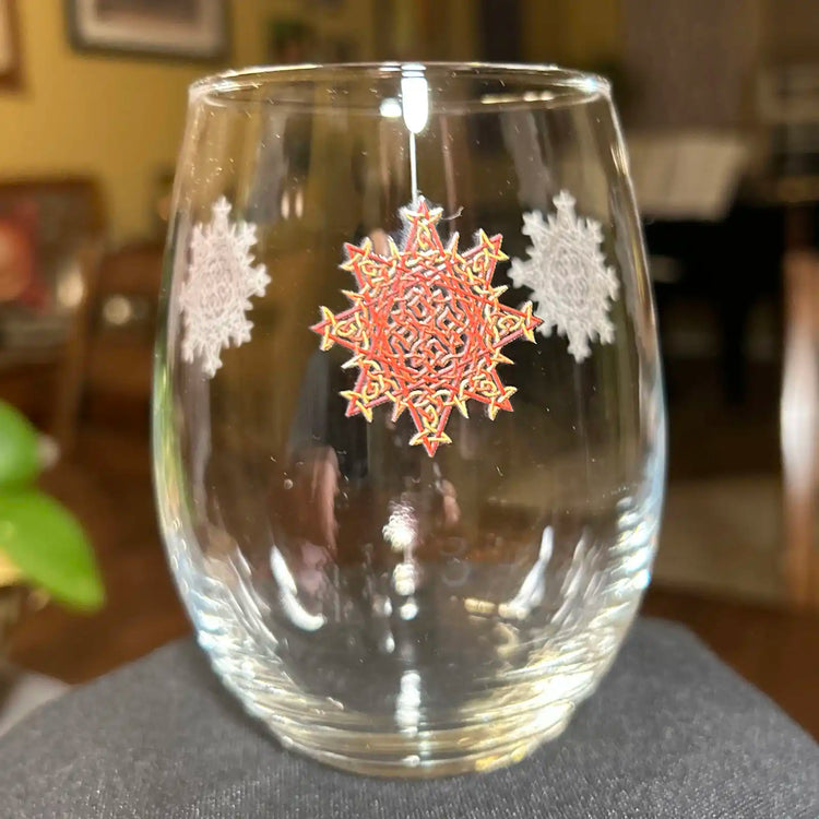 The front side of a stemless wine glass featuring the Fire Colour iteration of the Morning Star Fire Celtic knot design. The Morning Star Fire Celtic knot symbolizes Father Sun.