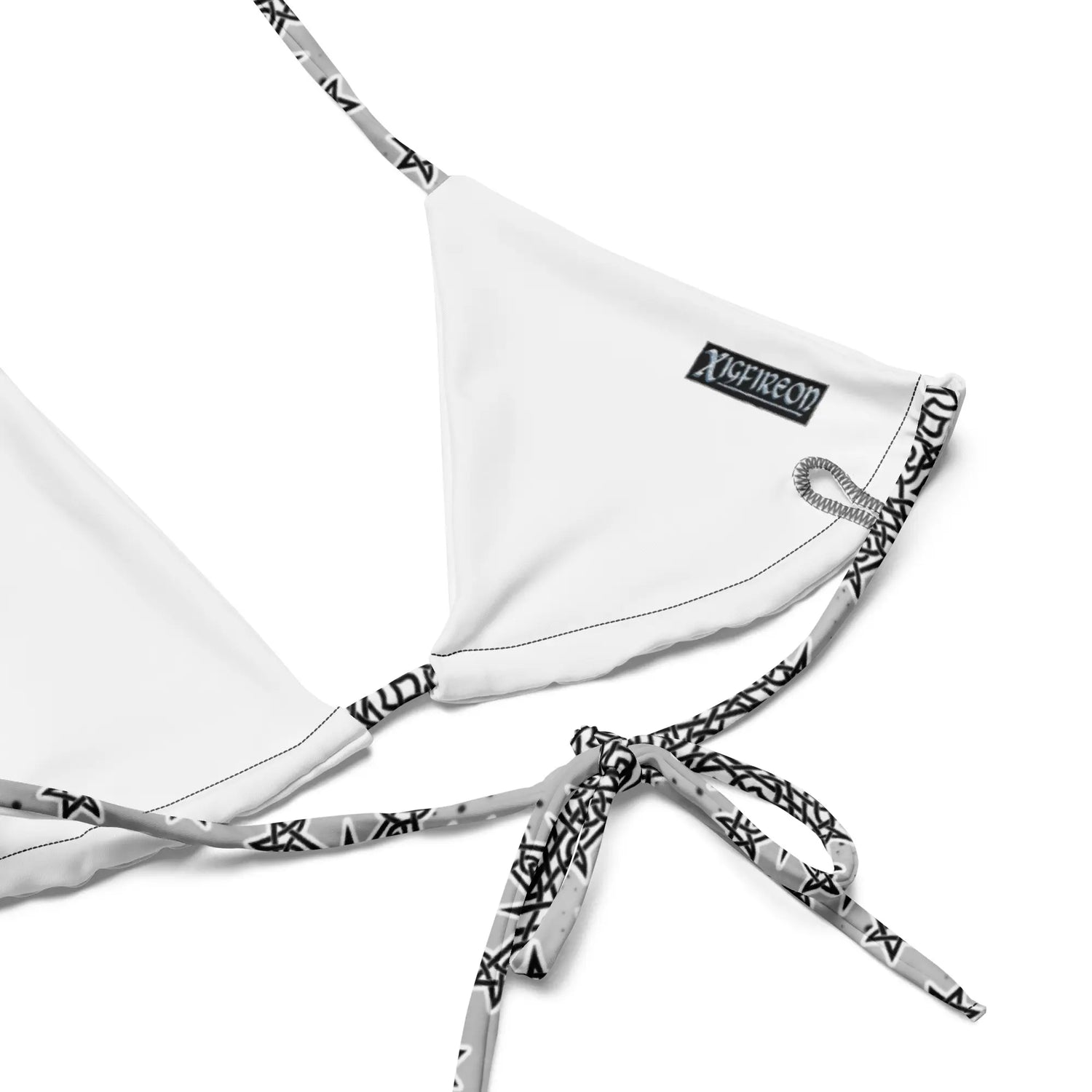 A view of the inside of a string bikini top featuring the Inverted Black & White Solid Cosmos iteration of the Morning Star Fire Celtic knot pattern.
