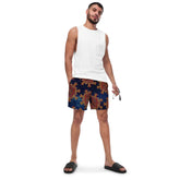 A young man wearing a pair of Xigfireon graphic swim trunks featuring the Fire Colour Cosmos patterned series of the Morning Star Fire Celtic knot design.