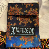 A close-up view of the inner pocket and logo on a pair of Xigfireon graphic swim trunks featuring the Fire Colour Cosmos (Small) patterned series of the Morning Star Fire Celtic knot design.