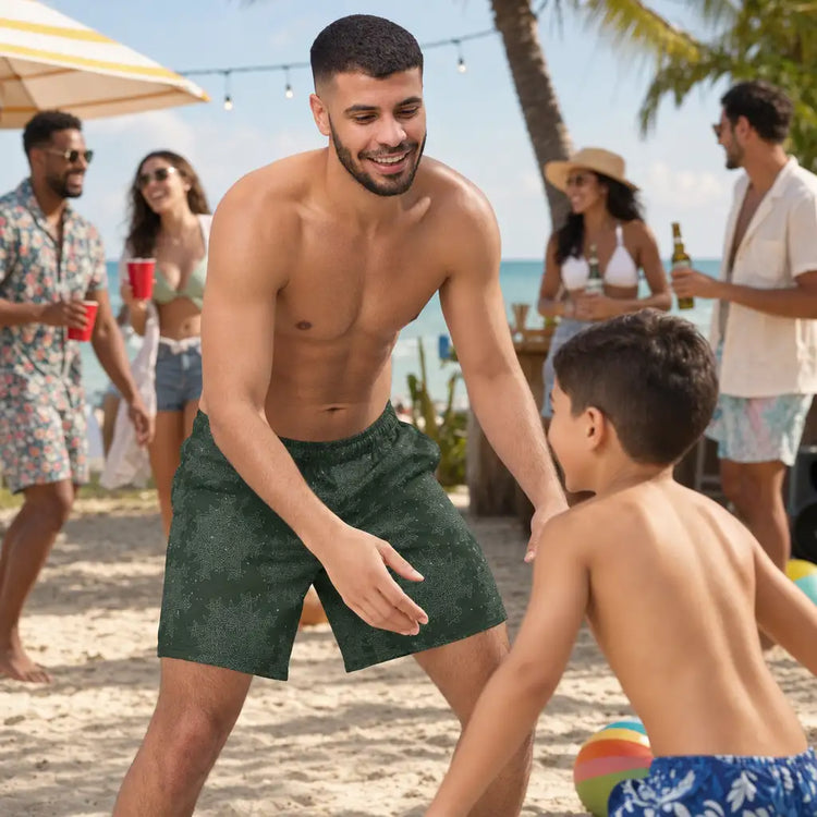 A man playing with his son at a beach party. The man is wearing a pair of Xigfireon swim trunks featuring the Midnight Cosmos version of the `Morning Star Fire` Celtic knot pattern.