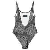 The back side of a Xigfireon graphic swimsuit featuring the Black & White Solid Forest patterned series of the Reach Of The Spirit Celtic knot design.