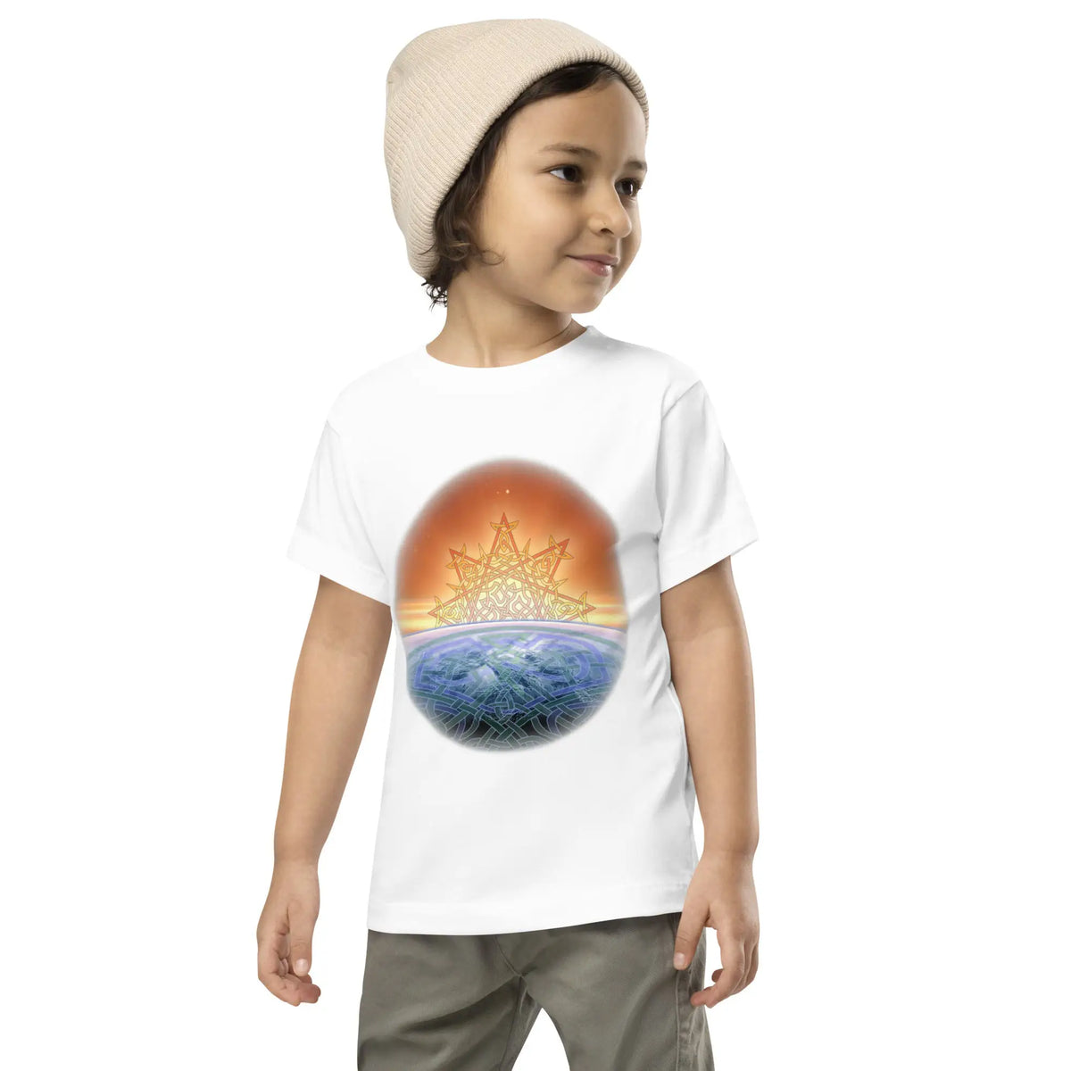 A young boy wearing a white Xigfireon toddler graphic t-shirt featuring the Derivation II Celtic knot merger design symbolizing the Sun and the Earth in their cosmic dance.