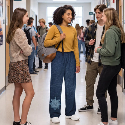 A group of four high school students talking in a school hallway. The central girl is wearing a mustard yellow long-sleeve shirt and a pair of Xigfireon Blue Slate wide-leg pants featuring the Morning Star Fire Celtic knot design.