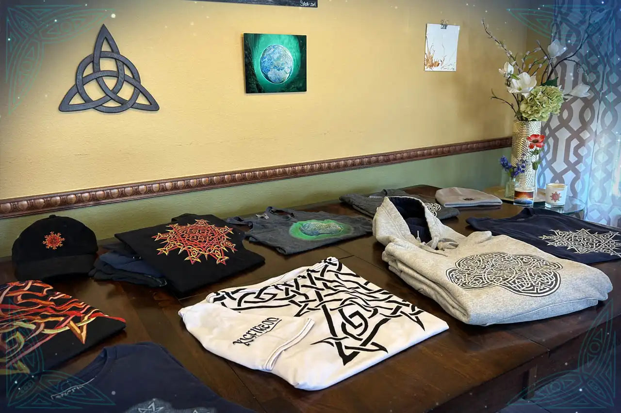 Xigfireon offers a variety of clothing items featuring original Celtic knot designs, from graphic tees and hoodies to pants, hats, and shoes.