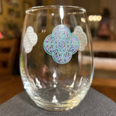 The front side of a stemless wine glass featuring the Living Colour iteration of the `Reach Of The Spirit` Celtic knot design. The `Reach Of The Spirit` Celtic knot symbolizes Mother Earth.