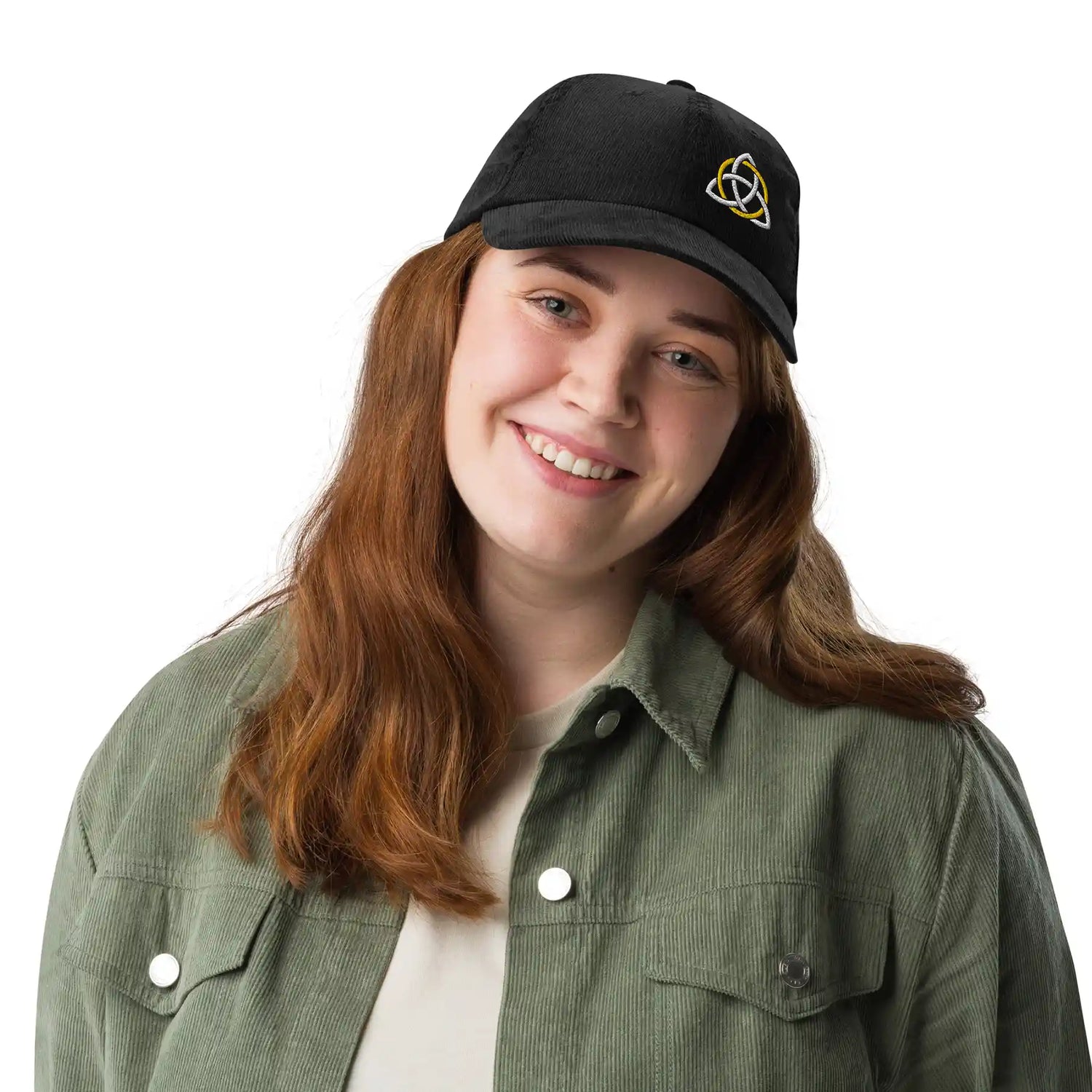 A young woman wearing a black Xigfireon vintage corduroy cap embroidered with a White & Gold Celtic Trinity Knot, offset to the left.