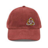The front side of a burgundy Xigfireon vintage corduroy cap embroidered with a White & Gold Celtic Trinity Knot, offset to the left.