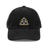 The front side of a black Xigfireon vintage corduroy cap embroidered with a White & Gold Celtic Trinity Knot.