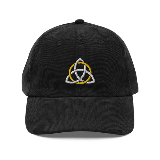 The front side of a black Xigfireon vintage corduroy cap embroidered with a White & Gold Celtic Trinity Knot.