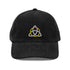 The front side of a black Xigfireon vintage corduroy cap embroidered with a White & Gold Celtic Trinity Knot.