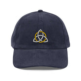 The front side of a navy blue Xigfireon vintage corduroy cap embroidered with a White & Gold Celtic Trinity Knot.