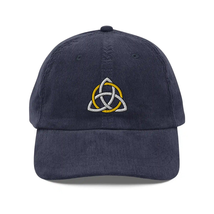The front side of a navy blue Xigfireon vintage corduroy cap embroidered with a White & Gold Celtic Trinity Knot.