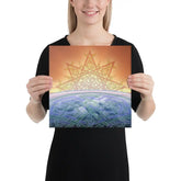 A young woman holding a 12 inch x 12 inch canvas print of the `Derivation II` Celtic knot design, which symbolizes the Sun and the Earth and their cosmic dance.
