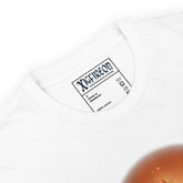 A view of the inside tag with the Xigfireon logo on a white Xigfireon t-shirt featuring the `Derivation II` Celtic knots merger design, symbolizing the cosmic dance between the Sun and the Earth.