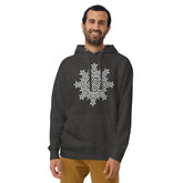 A young man wearing a charcoal heather Xigfireon graphic hoodie featuring the Black & White Hollow iteration of the `Morning Star Fire` Celtic knot design. The `Morning Star Fire` Celtic knot represents the Sun.