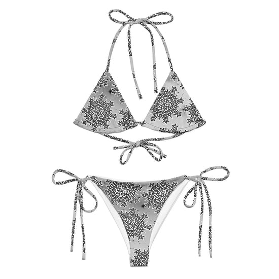 A view of the outside of a string bikini featuring the Inverted Black & White Solid Cosmos iteration of the `Morning Star Fire` Celtic knot pattern.