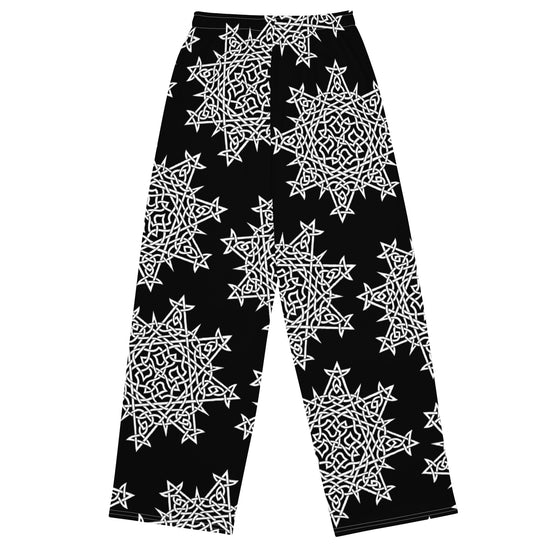 The back side of a pair of Xigfireon graphic wide leg pants featuring the Black and White Solid patterned series of the `Morning Star Fire` Celtic knot design.