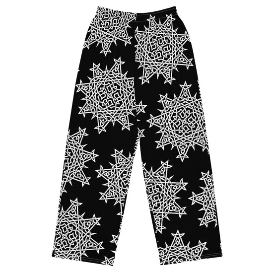 The front side of a pair of Xigfireon graphic wide leg pants featuring the Black and White Solid patterned series of the `Morning Star Fire` Celtic knot design.