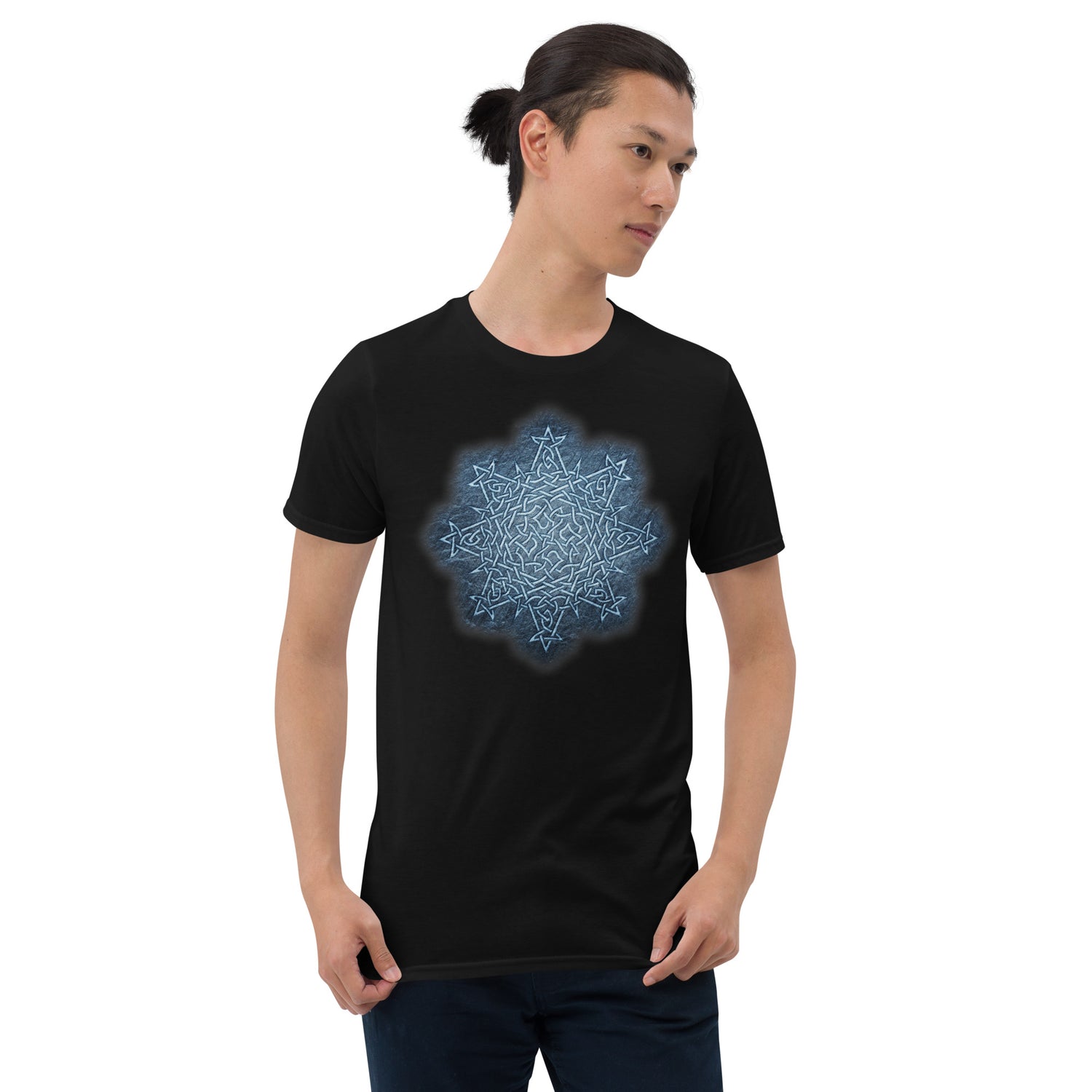 A young man wearing a black graphic t-shirt featuring the Blue Slate iteration of the `Morning Star Fire` Celtic knot design.