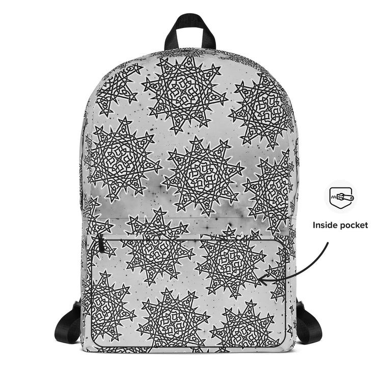 A view of the back of a Xigfireon backpack featuring the Black & White Solid Cosmos Inverted iteration of the `Morning Star Fire` Celtic knot pattern. A simple graphic and arrow indicate the location of the inside pocket.