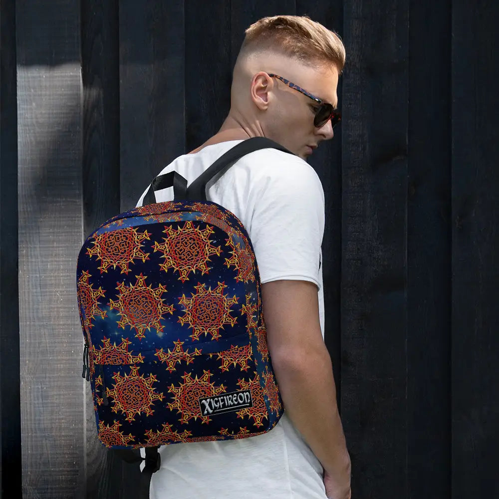 A student carrying a Xigfireon backpack featuring the Fire Colour Cosmos iteration of the `Morning Star Fire` Celtic knot pattern. The `Morning Star Fire` Celtic knot symbolizes the Sun.