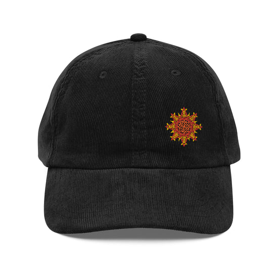 The front side of a black Xigfireon vintage corduroy cap embroidered with the Fire Colour iteration of the `Morning Star Fire` Celtic knot design offset to the left.