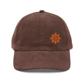 The front side of a brown Xigfireon vintage corduroy cap embroidered with the Fire Colour iteration of the `Morning Star Fire` Celtic knot design offset to the left.