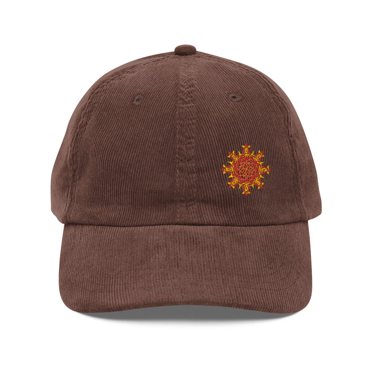 The front side of a brown Xigfireon vintage corduroy cap embroidered with the Fire Colour iteration of the `Morning Star Fire` Celtic knot design offset to the left.