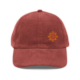 The front side of a burgundy Xigfireon vintage corduroy cap embroidered with the Fire Colour iteration of the `Morning Star Fire` Celtic knot design offset to the left.