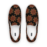 A view from above of a pair of Xigfireon canvas slip-on shoes featuring the Fire Colour on Black iteration of the `Morning Star Fire` Celtic knot pattern. The Xigfireon logo is visible inside each shoe.