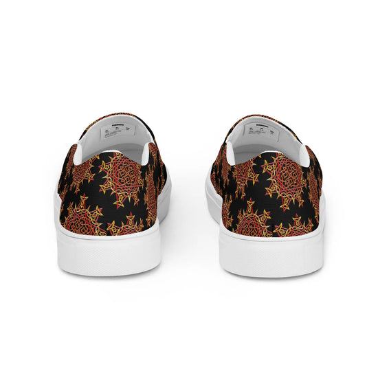 A view of the back of a pair of Xigfireon canvas slip-on shoes featuring the Fire Colour on Black iteration of the `Morning Star Fire` Celtic knot pattern. The `Morning Star Fire` Celtic knot represents the Sun.