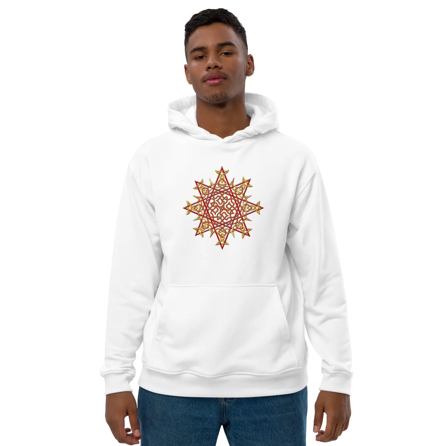 A young man wearing a white Xigfireon graphic eco-friendly hoodie featuring the Fire Colour iteration of the `Morning Star Fire` Celtic knot design. The `Morning Star Fire` Celtic knot symbolizes the Sun.