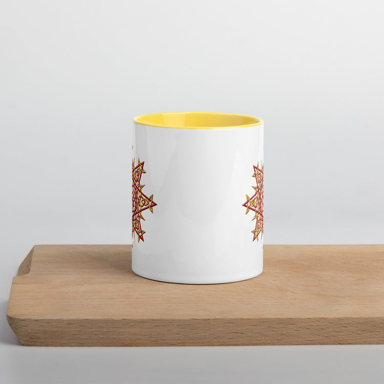 The front side of a Xigfireon white ceramic 11oz mug featuring the Fire Colour iteration of the `Morning Star Fire` Celtic knot design, with yellow handle and inside. This Celtic knot symbolizes Father Sun.