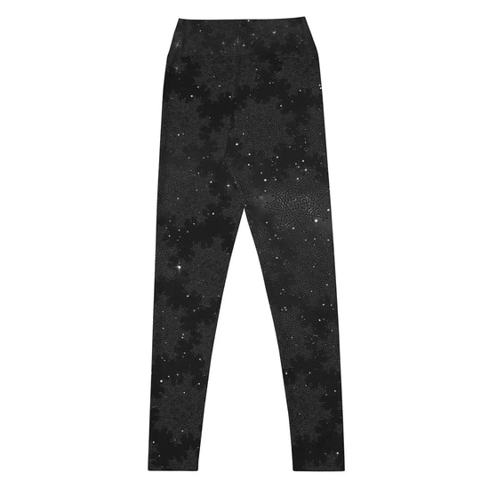 The back side of a pair of Xigfireon graphic yoga leggings featuring the Midnight Cosmos patterned series of the `Morning Star Fire` Celtic knot design.
