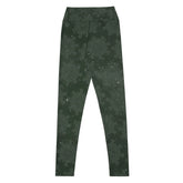 The back side of a pair of Xigfireon graphic yoga leggings featuring the Midnight Green Cosmos patterned series of the `Morning Star Fire` Celtic knot design.