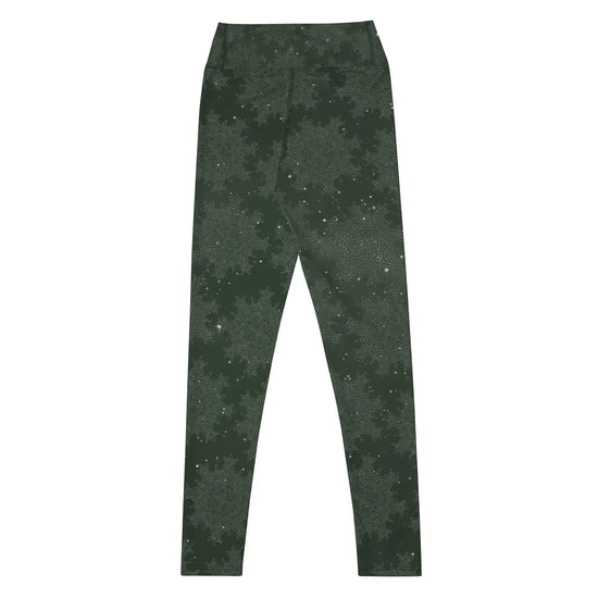 The back side of a pair of Xigfireon graphic yoga leggings featuring the Midnight Green Cosmos patterned series of the `Morning Star Fire` Celtic knot design.