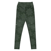 The front side of a pair of Xigfireon graphic yoga leggings featuring the Midnight Green Cosmos patterned series of the `Morning Star Fire` Celtic knot design.