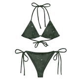 A view of the outside of a string bikini featuring the Midnight Green Solid Cosmos iteration of the `Morning Star Fire` Celtic knot pattern.