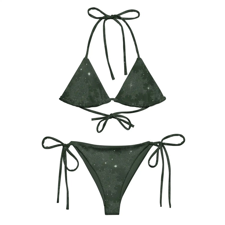 A view of the outside of a string bikini featuring the Midnight Green Solid Cosmos iteration of the `Morning Star Fire` Celtic knot pattern.