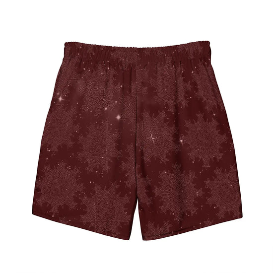 The back side of a pair of Xigfireon graphic swim trunks featuring the Midnight Red Cosmos patterned series of the `Morning Star Fire` Celtic knot design.