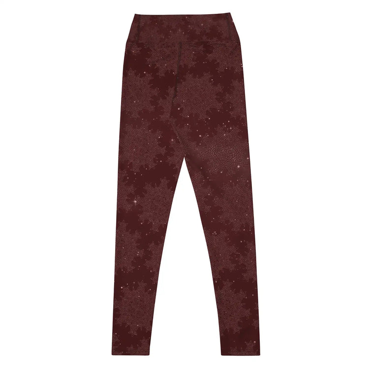 The back side of a pair of Xigfireon graphic yoga leggings featuring the Midnight Red Cosmos patterned series of the `Morning Star Fire` Celtic knot design.