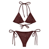 A view of the outside of a Xigfireon string bikini featuring the Midnight Red Cosmos iteration of the `Morning Star Fire` Celtic knot pattern.