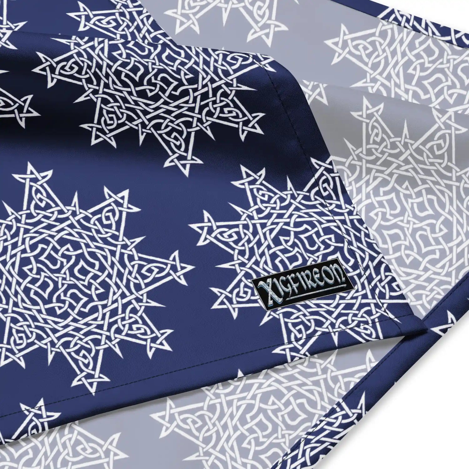 A close up view of the Xigfireon logo on a large sized (25.25 inch x 25.25 inch) `Morning Star Fire` Navy Blue and White bandana.