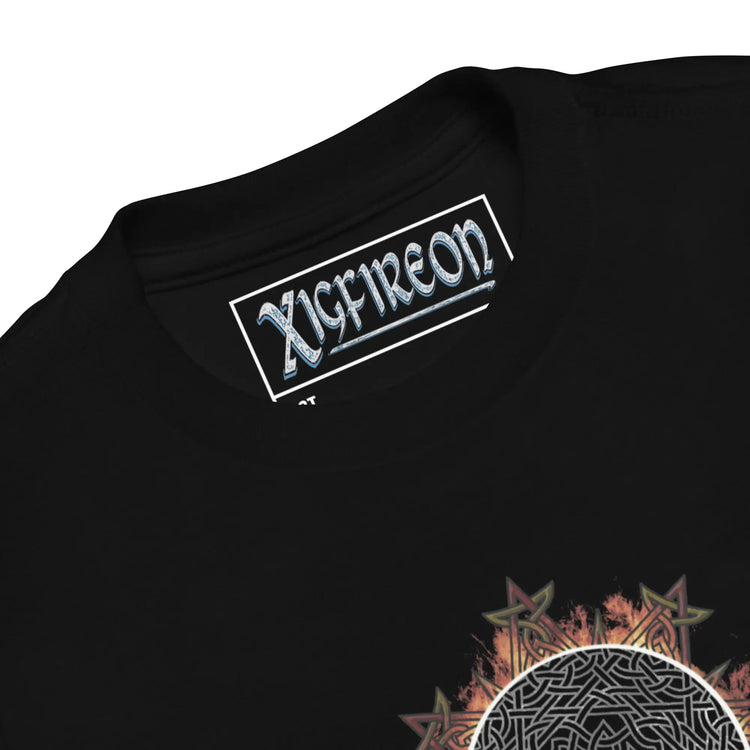 A close-up view of the logo and design on a black Xigfireon toddler graphic t-shirt featuring the Eclipsed iteration of the `Morning Star Fire` Celtic knot design. The `Morning Star Fire` Celtic knot is a powerful Sun symbol.