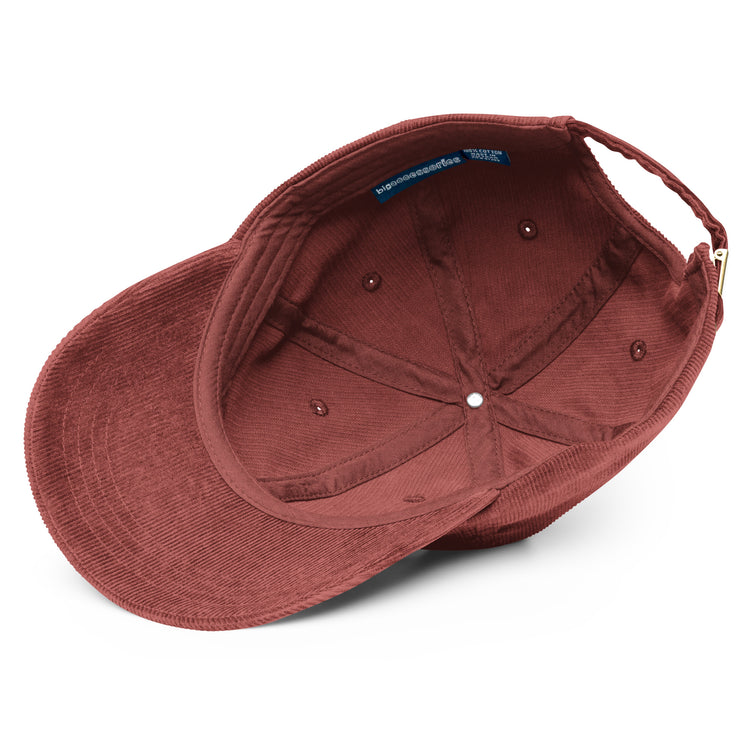A view of the inside of a burgundy Xigfireon vintage corduroy cap.